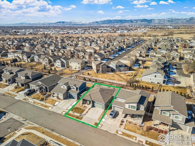 drone / aerial view with a residential view and a mountain view