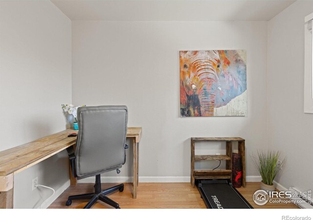 office with light wood-style floors and baseboards