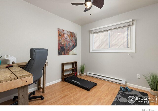 office area featuring ceiling fan, a baseboard radiator, baseboards, and light wood-style floors