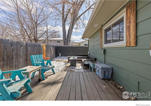 wooden terrace with a fenced backyard