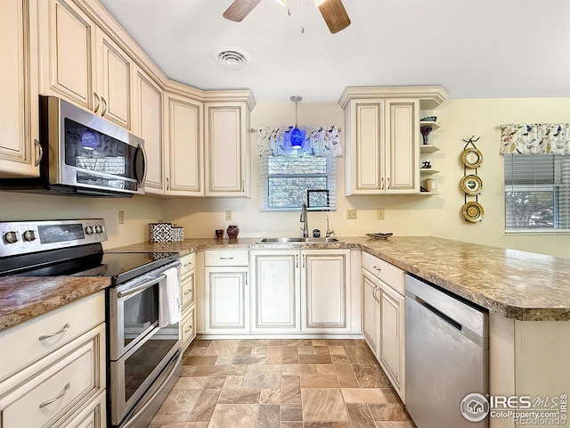 kitchen with decorative light fixtures, open shelves, stainless steel appliances, a sink, and a peninsula