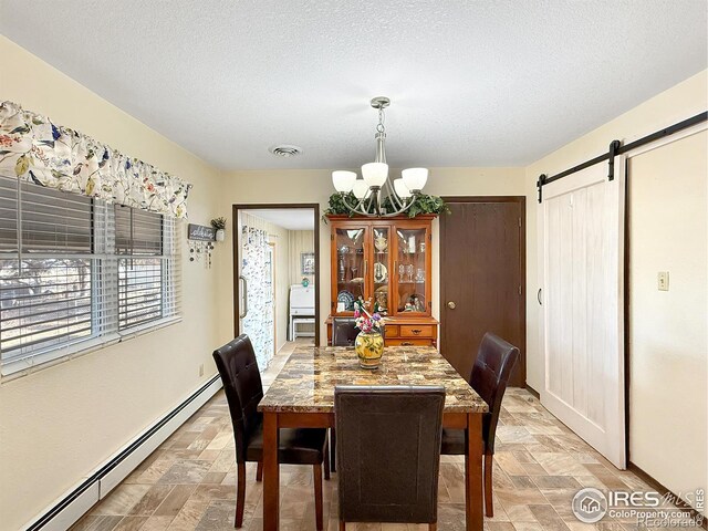 dining area featuring a baseboard radiator, stone finish flooring, visible vents, and a barn door