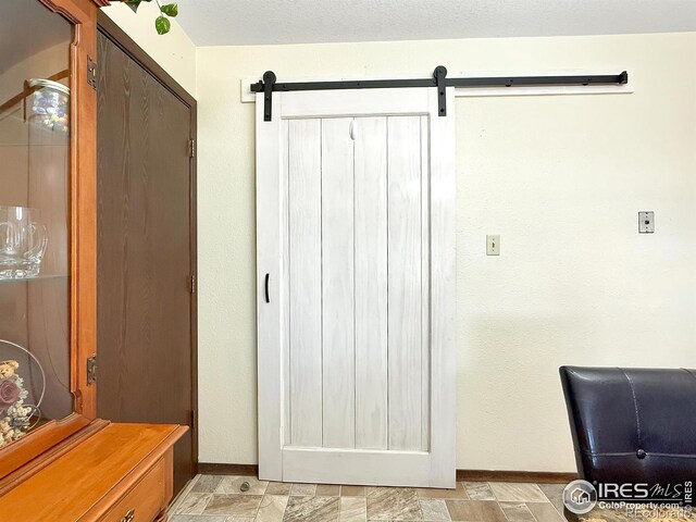 interior space featuring stone finish floor and baseboards