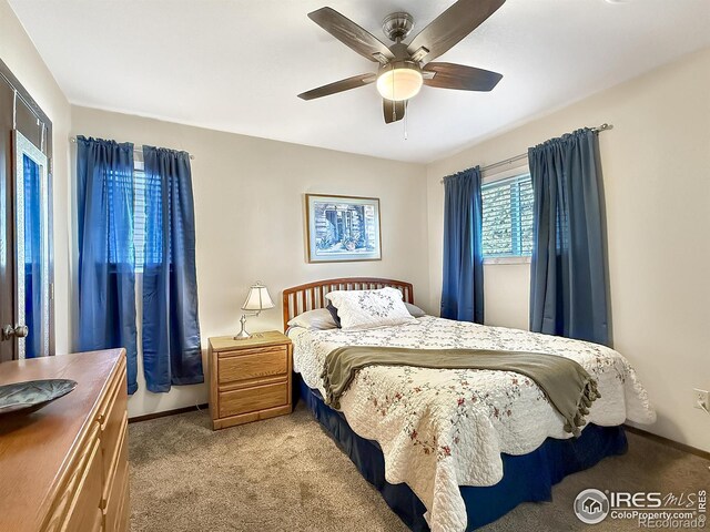 bedroom featuring light carpet, ceiling fan, and baseboards