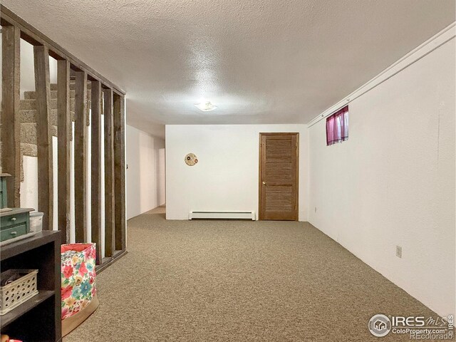 unfurnished room featuring carpet, a baseboard radiator, and a textured ceiling