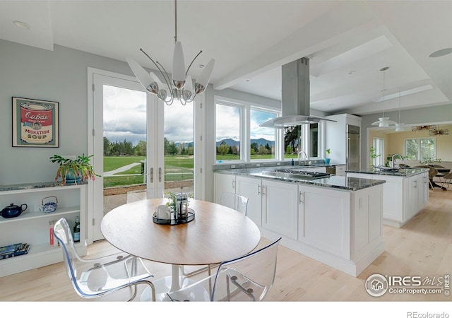 7034 Indian Peaks Trl, Boulder, CO 80301 - dining area featuring light wood finished floors, french doors, and a chandelier