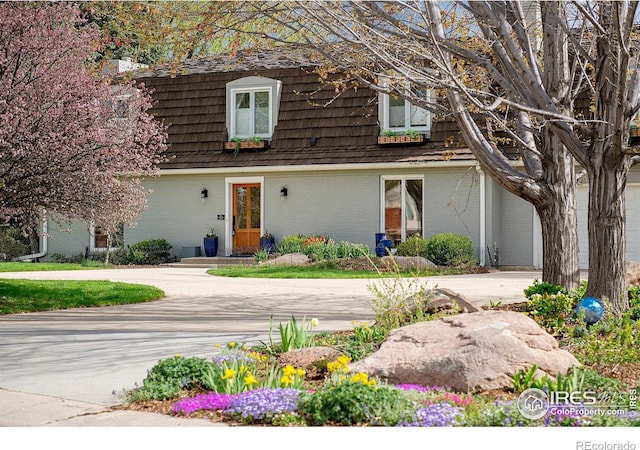7034 Indian Peaks Trl, Boulder, CO 80301 - view of front of property with brick siding and mansard roof