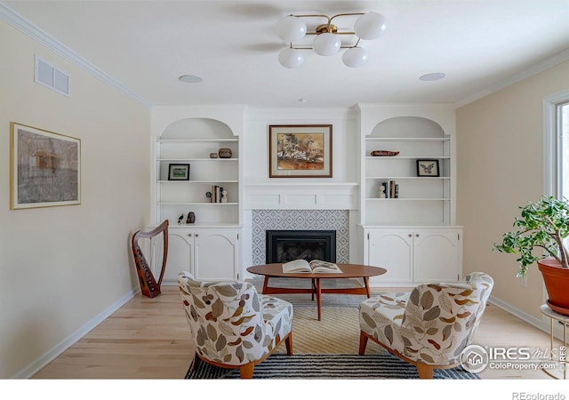 7034 Indian Peaks Trl, Boulder, CO 80301 - living area with light wood-style floors, baseboards, built in shelves, a fireplace, and crown molding