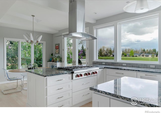 7034 Indian Peaks Trl, Boulder, CO 80301 - kitchen featuring island exhaust hood, stainless steel gas cooktop, white cabinetry, and dark stone countertops