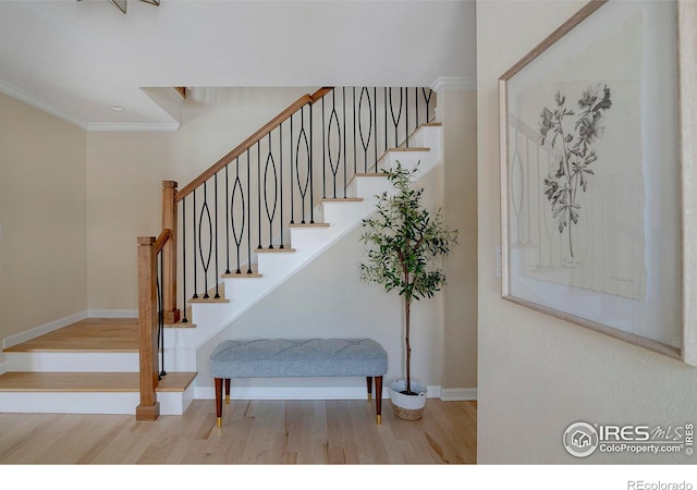 7034 Indian Peaks Trl, Boulder, CO 80301 - staircase with wood finished floors, baseboards, and crown molding