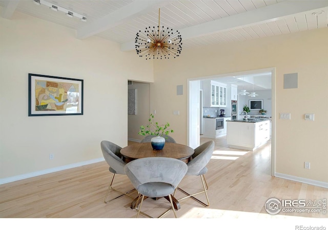 7034 Indian Peaks Trl, Boulder, CO 80301 - dining space with beam ceiling, light wood-type flooring, a chandelier, and baseboards