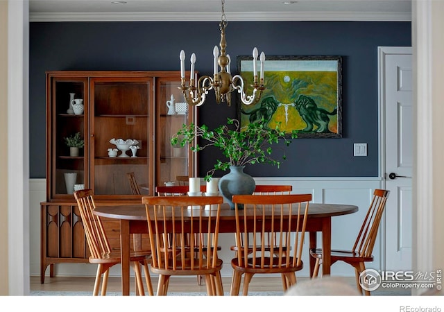 7034 Indian Peaks Trl, Boulder, CO 80301 - dining space with a chandelier, crown molding, wainscoting, and a decorative wall