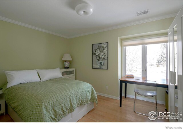 7034 Indian Peaks Trl, Boulder, CO 80301 - bedroom with light wood-type flooring, ornamental molding, and baseboards