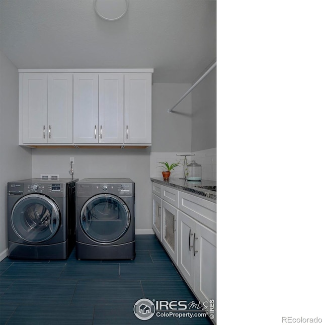 7034 Indian Peaks Trl, Boulder, CO 80301 - laundry room featuring washing machine and clothes dryer, cabinet space, and baseboards