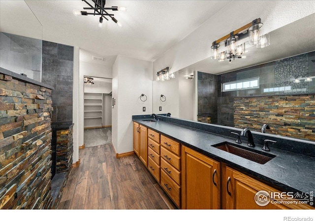 11837 County Road 39, Fort Lupton, CO 80621 - full bath with a sink, double vanity, a chandelier, and wood finished floors