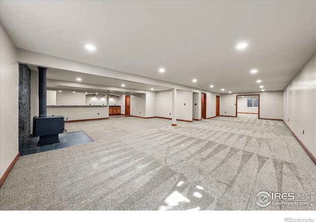 11837 County Road 39, Fort Lupton, CO 80621 - finished basement with a wood stove, carpet, and recessed lighting