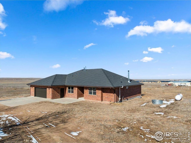 11837 County Road 39, Fort Lupton, CO 80621 - ranch-style house with roof with shingles, a garage, driveway, and brick siding