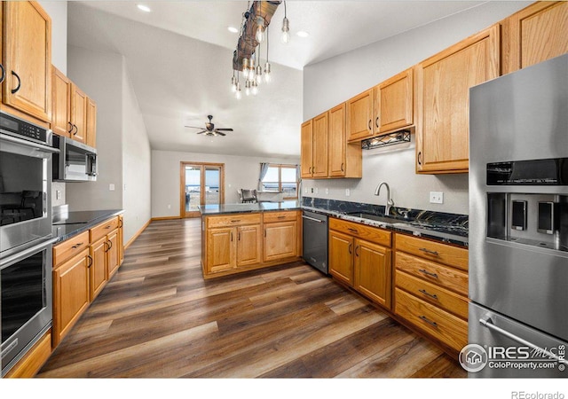 11837 County Road 39, Fort Lupton, CO 80621 - kitchen with a peninsula, appliances with stainless steel finishes, a sink, dark countertops, and dark wood-style floors