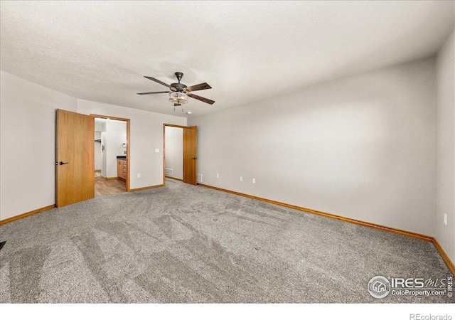 11837 County Road 39, Fort Lupton, CO 80621 - unfurnished bedroom featuring a textured ceiling, baseboards, and carpet floors