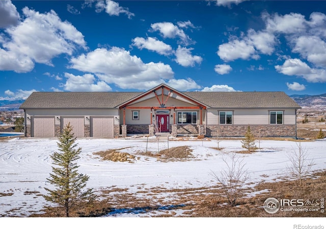 view of front of property featuring stone siding and an attached garage