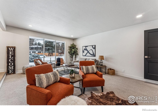 living area featuring carpet floors, baseboards, a textured ceiling, and recessed lighting