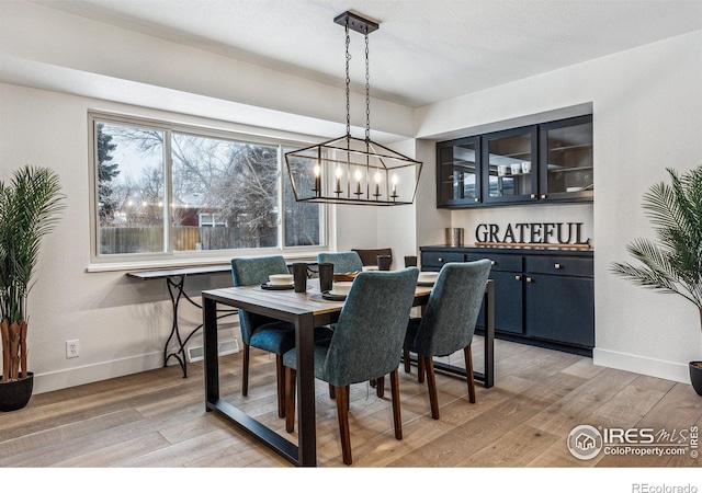 dining room featuring baseboards and light wood-style floors