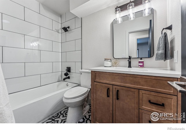 full bathroom featuring toilet, a textured wall, bathing tub / shower combination, and vanity