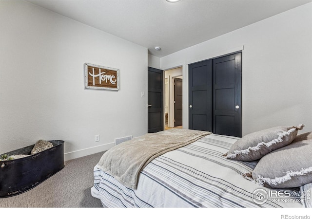 carpeted bedroom featuring visible vents and baseboards