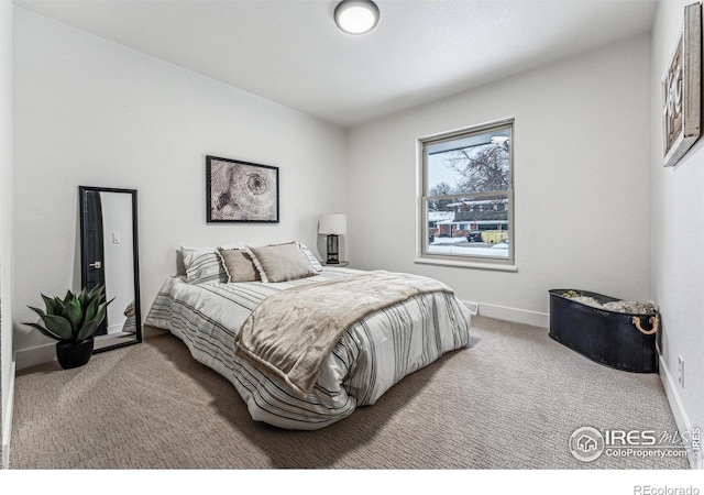 carpeted bedroom featuring baseboards