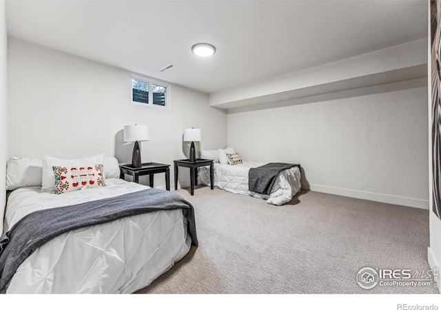 carpeted bedroom featuring visible vents and baseboards