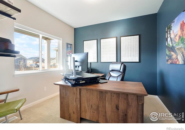 carpeted office space with visible vents and baseboards