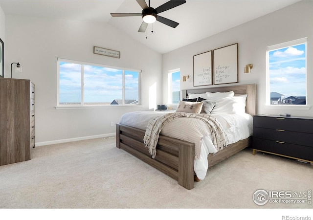 bedroom featuring lofted ceiling, light colored carpet, ceiling fan, and baseboards