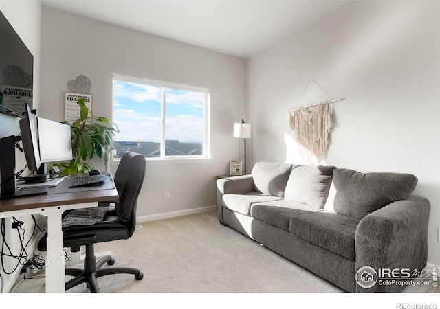 carpeted home office featuring baseboards