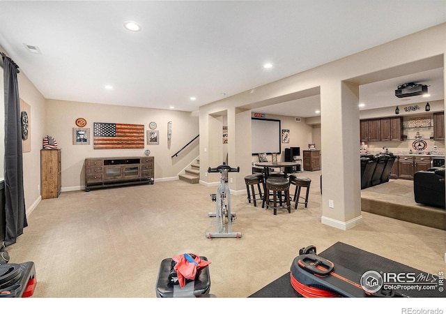 exercise area featuring light carpet, visible vents, baseboards, and recessed lighting