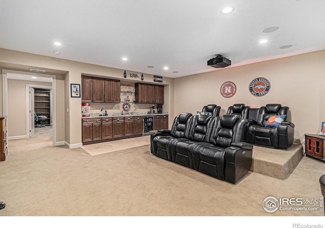 home theater with recessed lighting, light carpet, beverage cooler, baseboards, and wet bar