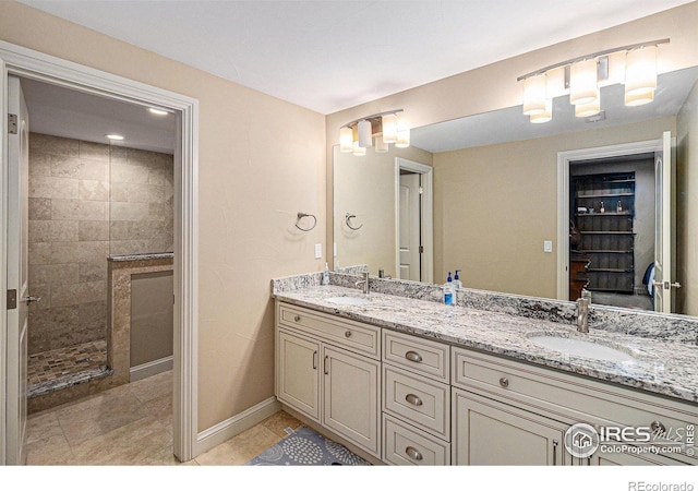 full bath with a walk in shower, double vanity, tile patterned flooring, and a sink