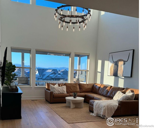 living room featuring a high ceiling, a mountain view, and wood finished floors