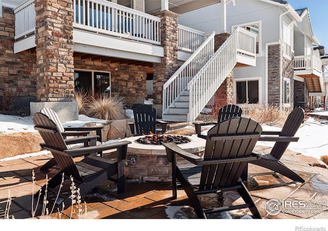 view of patio with stairs and an outdoor fire pit