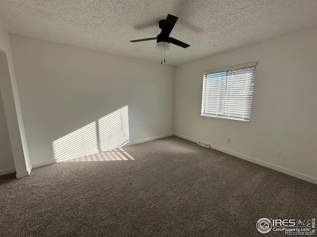 unfurnished room with carpet floors, a textured ceiling, baseboards, and a ceiling fan