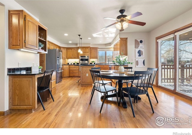 dining area with a ceiling fan, recessed lighting, baseboards, and light wood finished floors