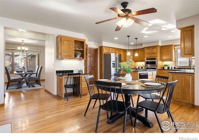 dining area with baseboards, ceiling fan with notable chandelier, light wood-style flooring, and recessed lighting