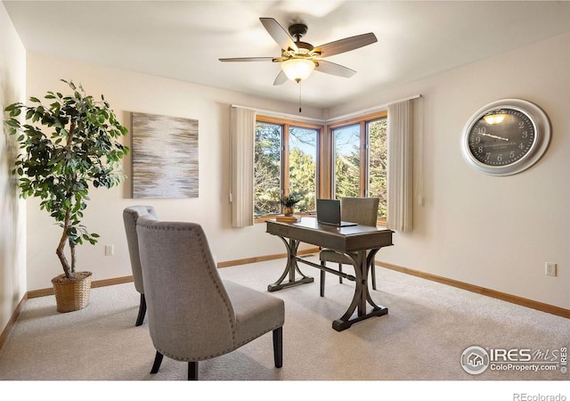 office with baseboards, a ceiling fan, and light colored carpet