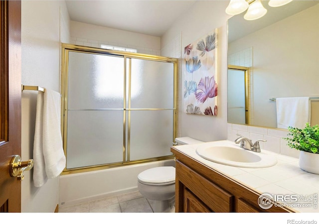 full bath with toilet, shower / bath combination with glass door, vanity, backsplash, and tile patterned floors