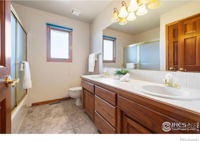 full bathroom with toilet, backsplash, a sink, and visible vents