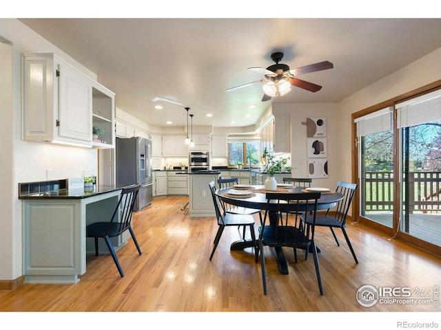 dining room with recessed lighting, a ceiling fan, and light wood-style flooring