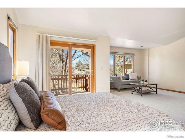 carpeted bedroom featuring access to outside and baseboards