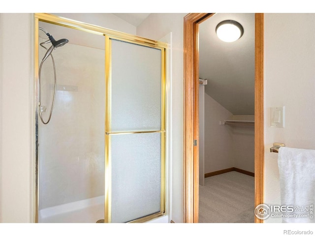 full bath with lofted ceiling and a shower stall