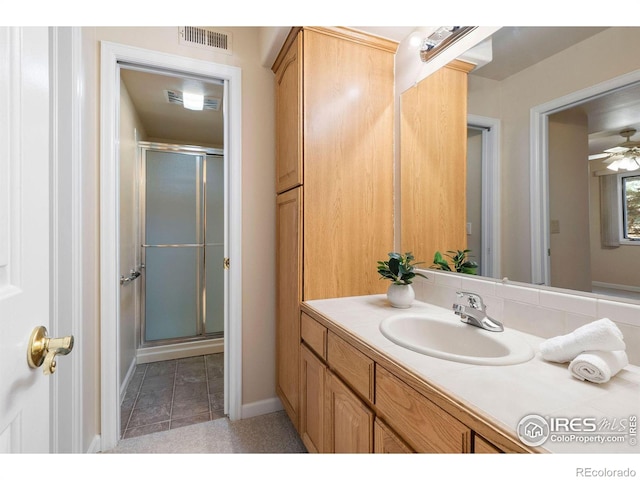 full bath featuring baseboards, visible vents, a shower stall, and vanity