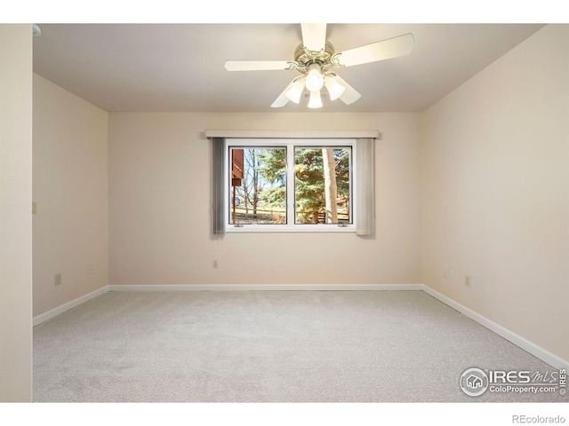 empty room featuring carpet floors, baseboards, and a ceiling fan