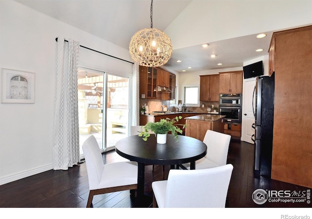 dining area featuring dark wood finished floors, vaulted ceiling, baseboards, and recessed lighting